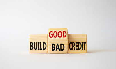 Build Good or Bad Credit symbol. Wooden cubes with words Build Bad Credit vs Build good credit. Beautiful white background. Business concept. Copy space
