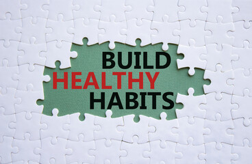 Healthy habits symbol. Concept word Build Healthy habits on white puzzle. Beautiful grey green background. Healthy lifestyle and Healthy habits concept. Copy space
