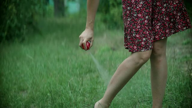 Woman anti mosquito fleas spray . Spraying repellent insects ticks