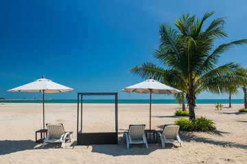 Relax sunbed or deck chairs with parasol on beach, Cha Am