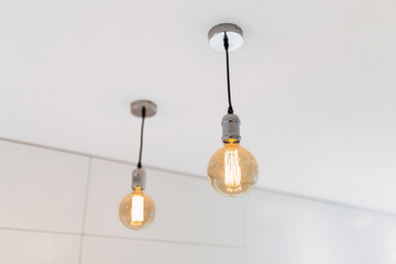 Vintage light bulb hanging from ceiling for decoration in living room