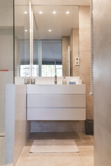 General views of the bright bathroom with shower, washbasin and mirror