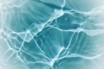 Blue water with ripples on the surface. Defocus blurred transparent blue colored clear calm water surface texture with splashes and bubbles. Water waves with shining pattern texture background.