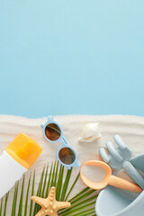The concept of a children's summertime beach respite. Top view of beach toys, eyewear, sunscreen...