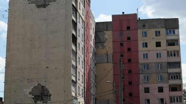 Traces of an artillery shell hitting a multi-storey residential building. Part of the building was destroyed by the shock wave and shrapnel. Shelling at home.