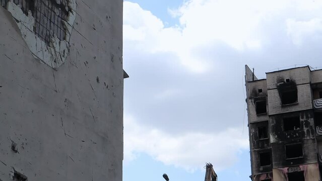 Traces of an artillery shell hitting a multi-storey residential building. Part of the building was destroyed by the shock wave and shrapnel. Shelling at home.