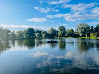 Obraz na płótnie Canvas Trees reflection on the pond water surface, sky reflection, lakeside background