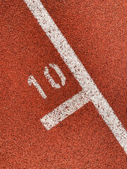 Sport stadium, Red tartan running track with white painted number 10, no person 