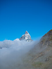 Fototapeta na wymiar Zermatt, Switzerland - July 2nd 2023: The Matterhorn peak over the fog. View from Gorner Glacier.