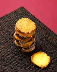 A set of cookies with lemon and pumpkin seeds flavor, lavender flavor and pistachio-chocolate icing, in a gift box. Close-up