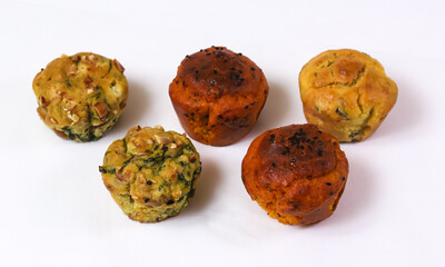 Snack muffins. Snack cupcakes with sausage, ham, cheese, sun-dried tomatoes and other ingredients and spices. Shallow depth of field