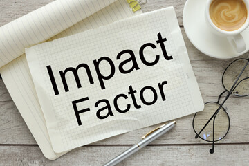 the torn page lies on the notebook. words IMPACT FACTOR.