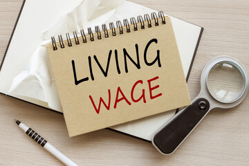Living Wage craft notepad with a spring. text on the page