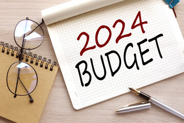 Budget 2024. top view of an open notebook with text. glasses near the notebook.close-up