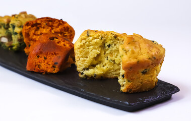 Sliced muffins. Snack muffins with ham, cheese, sun-dried tomatoes and other ingredients and spices. Shallow depth of field