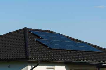 Solar roof. Solar panels on top of a village home, renewable energy