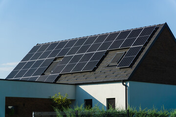 Solar roof. Solar panels on top of a village home, renewable energy