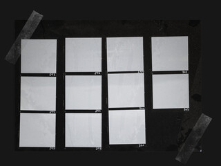 handcopy medium format paper sheet with empty frames fixed by transparent sticker tape on black...