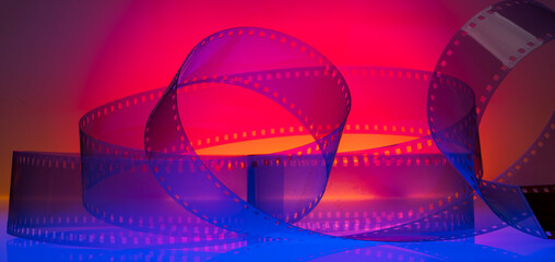 abstract colored cinematic background with film strip.background banner for film premiere festivals production. - obrazy, fototapety, plakaty