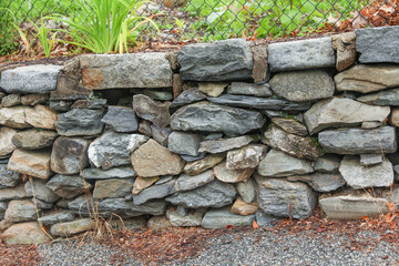 stone wall, weathered by time, evoking strength, resilience, and the enduring beauty of nature's elements. Symbolizing stability and history