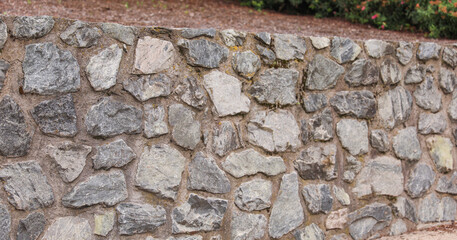stone wall, weathered by time, evoking strength, resilience, and the enduring beauty of nature's...