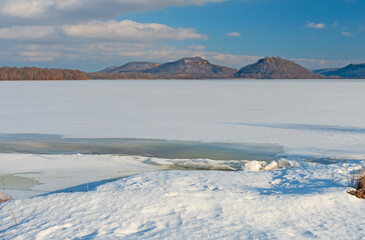 Distant Hills Above a Frozen River