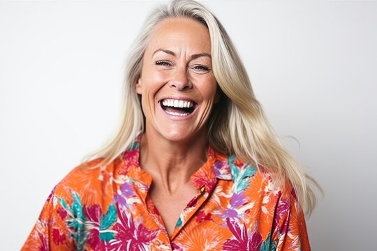 Close up portrait of a happy mature woman laughing isolated on a white background