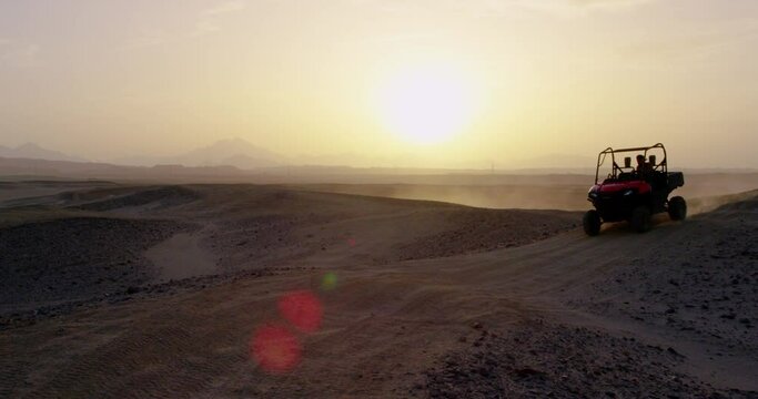 Landscape of hilly terrain in the desert in egypt and buggy car.