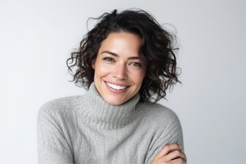 Portrait of a smiling woman looking at the camera over white background