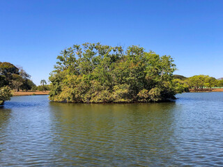 Small tropical island in the middle of freshwater lake