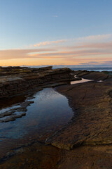 Fototapeta na wymiar Rock and water with beautiful sunrise sky.