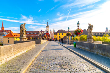 The Old Main bridge or Mainbrücke, with statues of holy figures and the Wurzburg Cathedral and...