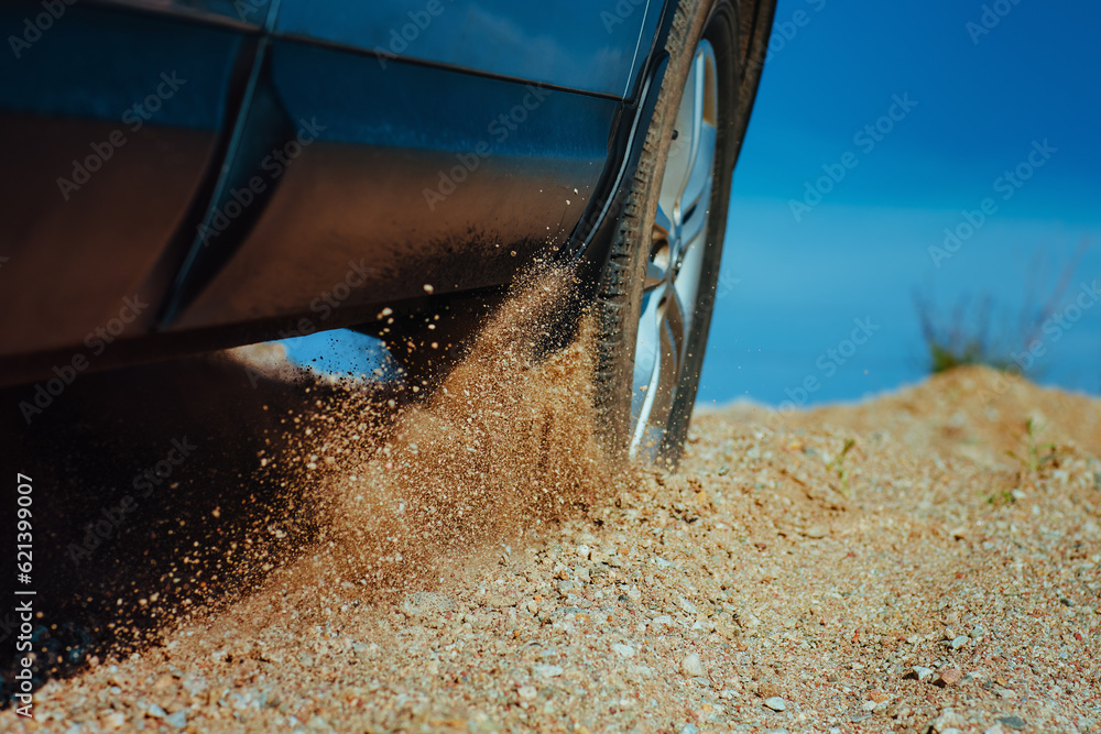 Sticker Car wheel slips on the sand in desert close-up view