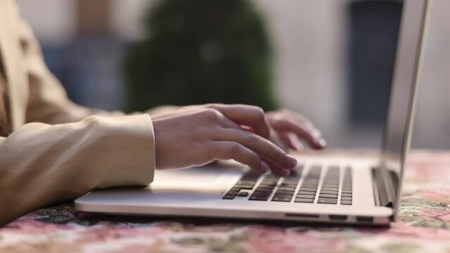 social network, freelancer working, keyboard in cafe. Businesswoman typing on laptop outside, working in front of keyboard, pretty brunette woman typing an email on laptop computer, writing blog