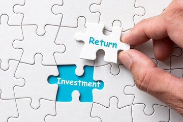Return of investment concept using white puzzle
