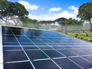 Blurred photovoltaic panels provide power to small area in local park, concept of sustainable power and saving environment