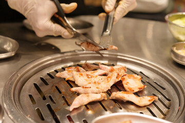 Chef Grilling meat pork on stove serve in restaurant. Korean food and BBQ traditional style