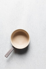 Top view of a cream and mauve ramekin with a handle, flat lay of an oven safe ramekin for baking