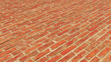 A wall of red bricks as a background.