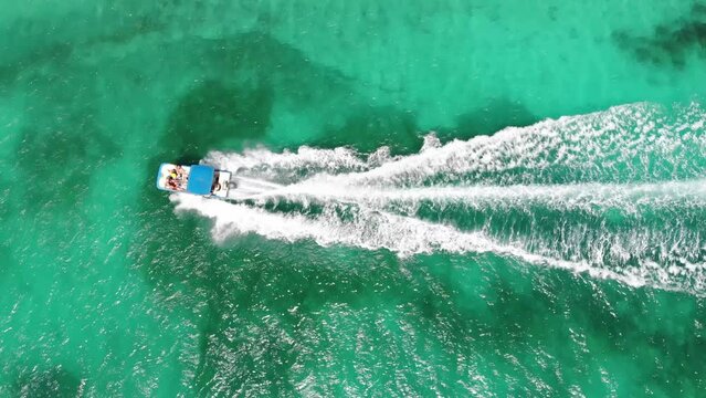 Top view image of the Caribbean Sea with a speeding boat cortanto and leaving the waves
