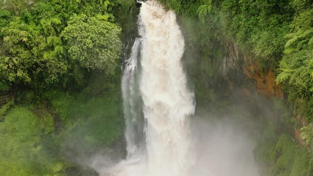 Beautiful waterfall in green forest. Telun Berasap Falls in jungle. Sumatra, Jambi, Indonesia.