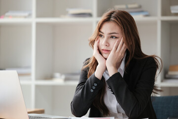 Obraz premium Business women are stressed while working on laptop, Tired asian businesswoman with headache at office, feeling sick at work, copy space