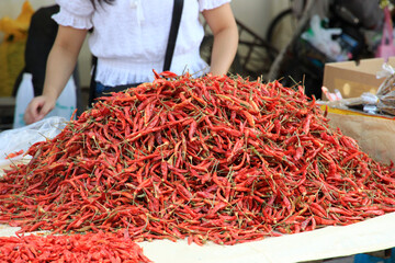 In the market, a large number of fresh red dried chilies are waiting for sale.Dried chilies for...