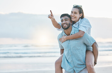 Couple, piggyback on beach and love, travel and holiday, mockup space and happy together outdoor. Summer, support and care with affection, man and woman pointing in nature with adventure by the ocean