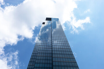 Obraz na płótnie Canvas Glass Skyscraper Or Tower, Blue Sky on Background. Business Development Or Financial Center concept. Horizontal Plane. Modern Building. Insurance Company 
