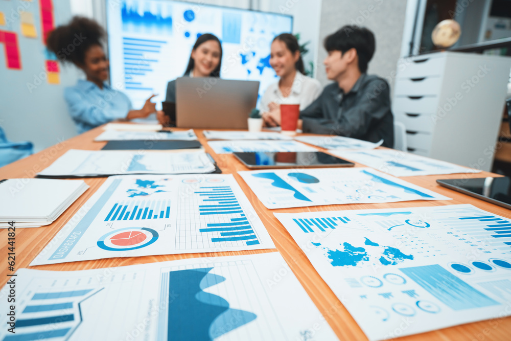 Poster focus financial dashboard paper showing graphs and chart with blurred background of diverse business