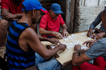 Latin group of elderly men playing dominoes in Old Havana Cuba, Caribbean black people