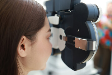 Close-up Beautiful patient's vision gets visual acuity test at Ophthalmology clinic.