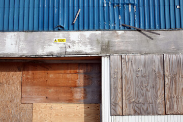 'danger fragile roof' sign on a blue corrugated metallic construction - Aberdeen - Grampian - Scotland - UK