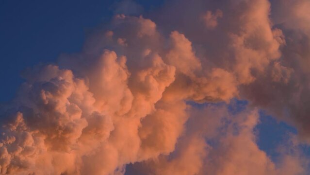 Hot Glowing colorful Smoke Plume sunlit while emitting Greenhouse gas into atmosphere during late evening from Paper mill Industry at Pitea Sweden.